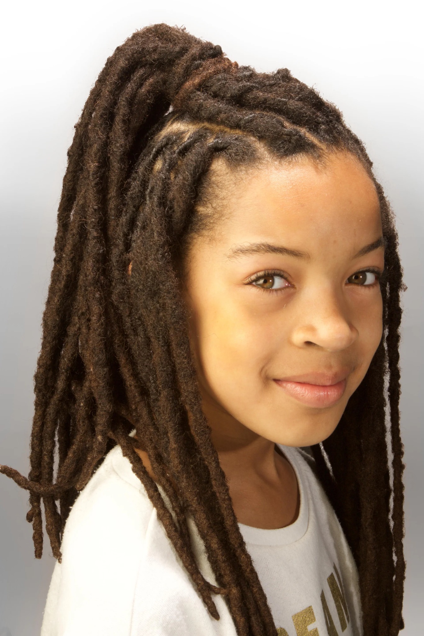 Long locs styled into a high half-up finish
